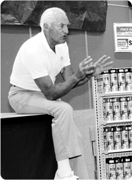 Mr Sam Teaching while sitting on a box