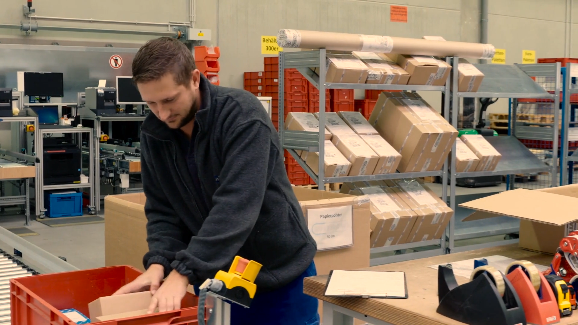 A man packs products at a high-tech distribution center