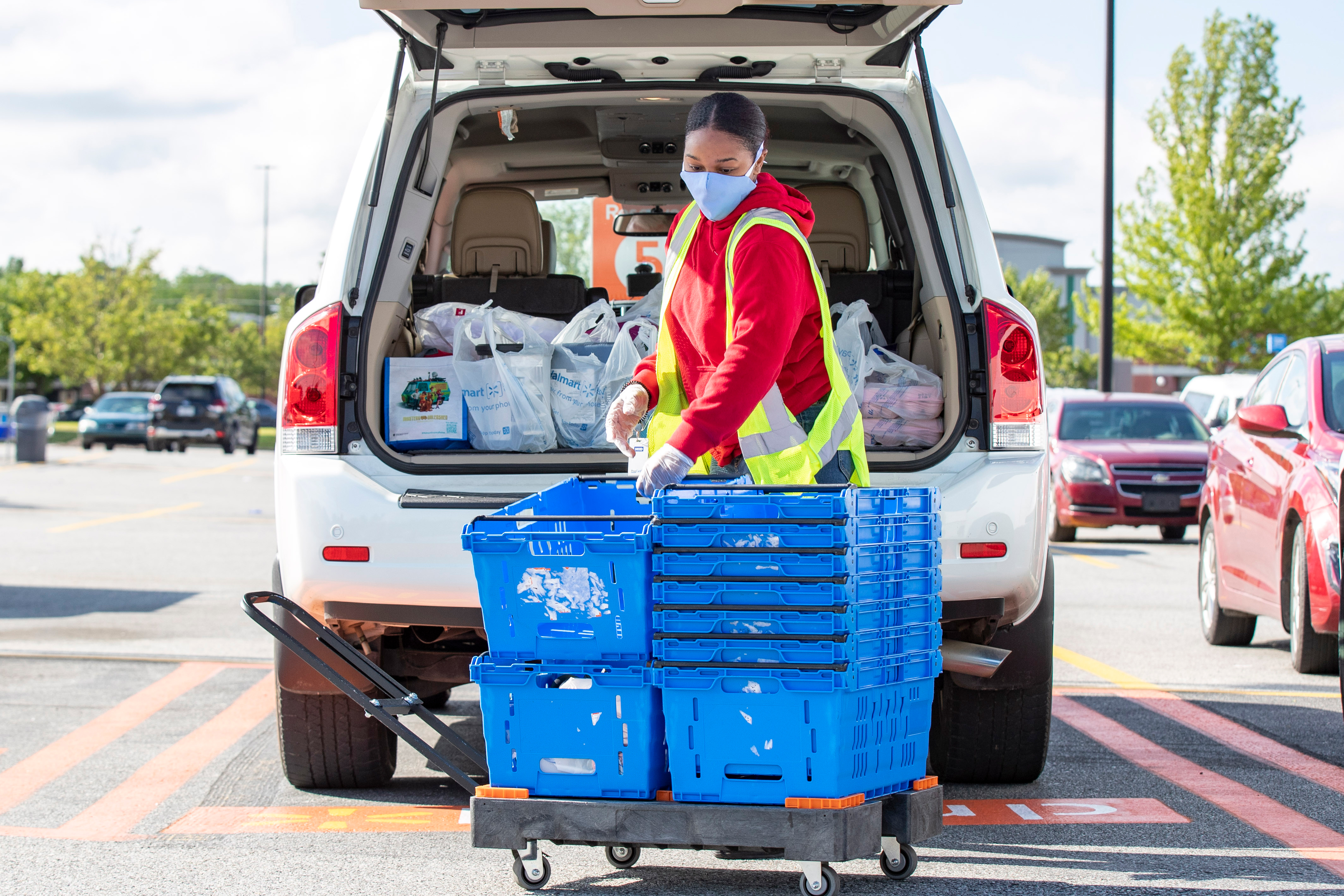 An associate wears a mask while loading a pickup order