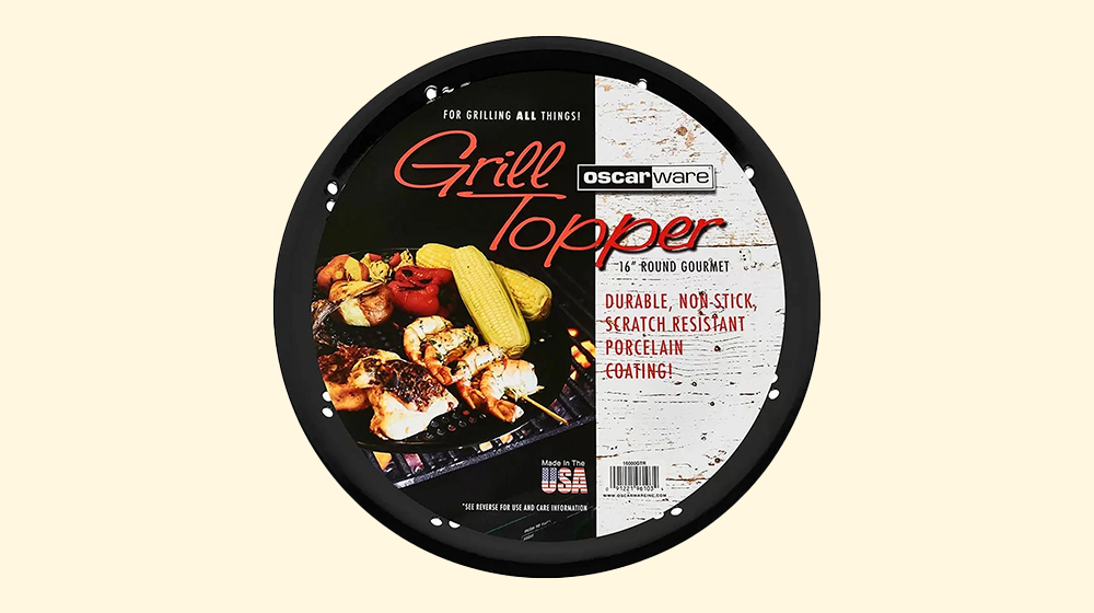 Oscarware round grill topper designed for versatile cooking. The image highlights grilled vegetables and meats, including corn and chicken, on a black non-stick surface. Visible text emphasizes durability, scratch resistance, and porcelain coating. The product is made in the USA, as noted on the packaging.
