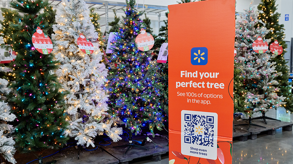 Holiday tree display with shopping sign