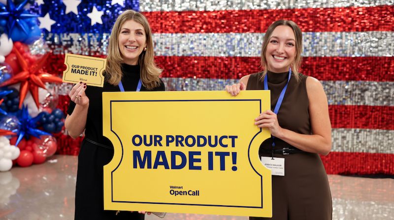Two individuals hold a large yellow sign reading 'OUR PRODUCT MADE IT!' at the Open Call event. The backdrop features a sparkling American flag design with red, white, and blue balloons. Visible text includes 'Walmart Open Call' on the sign.
