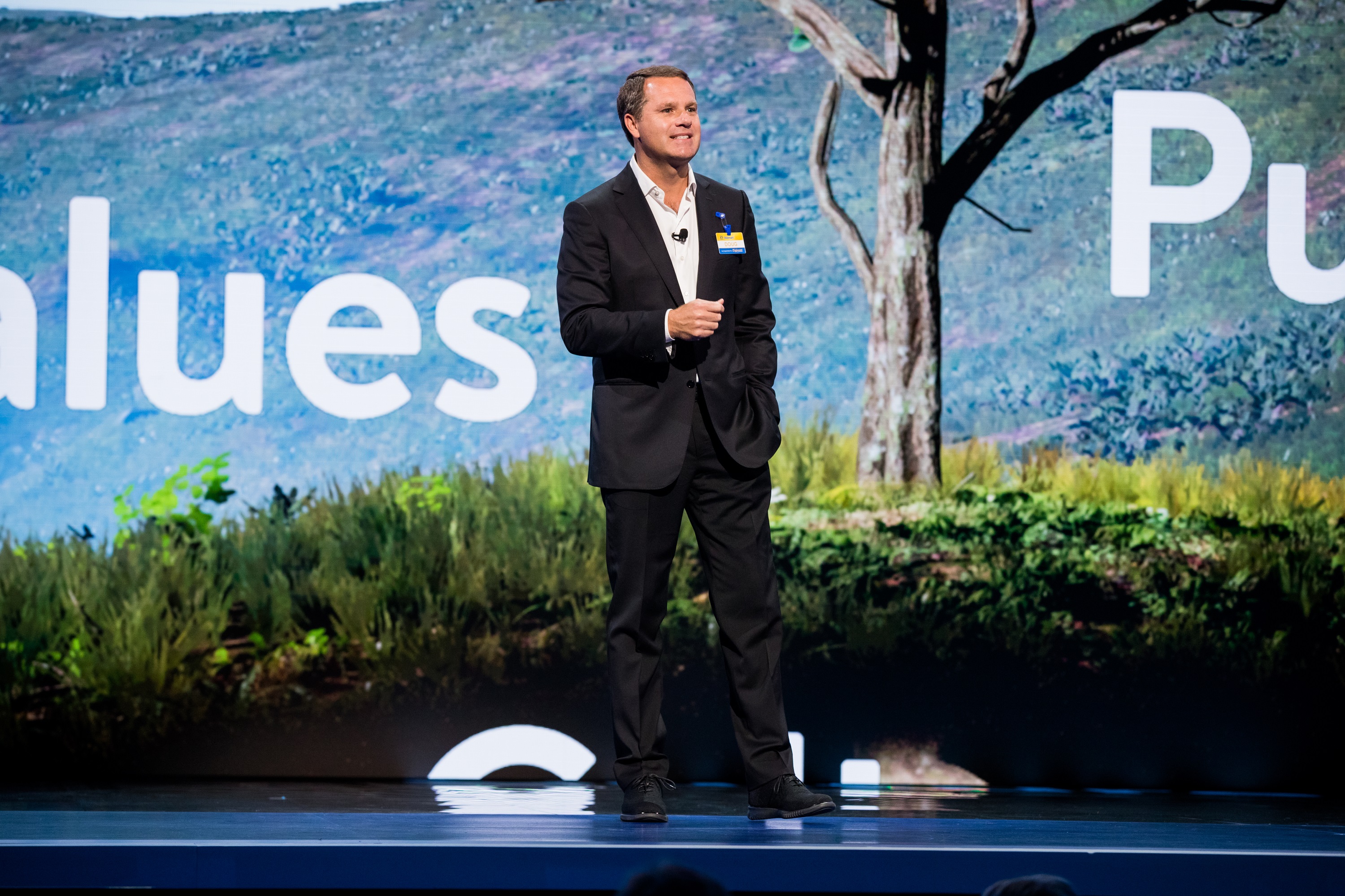 Doug McMillon, President and CEO of Walmart, speaks in front of tree at Walmart Associate Meeting during Shareholders 2018