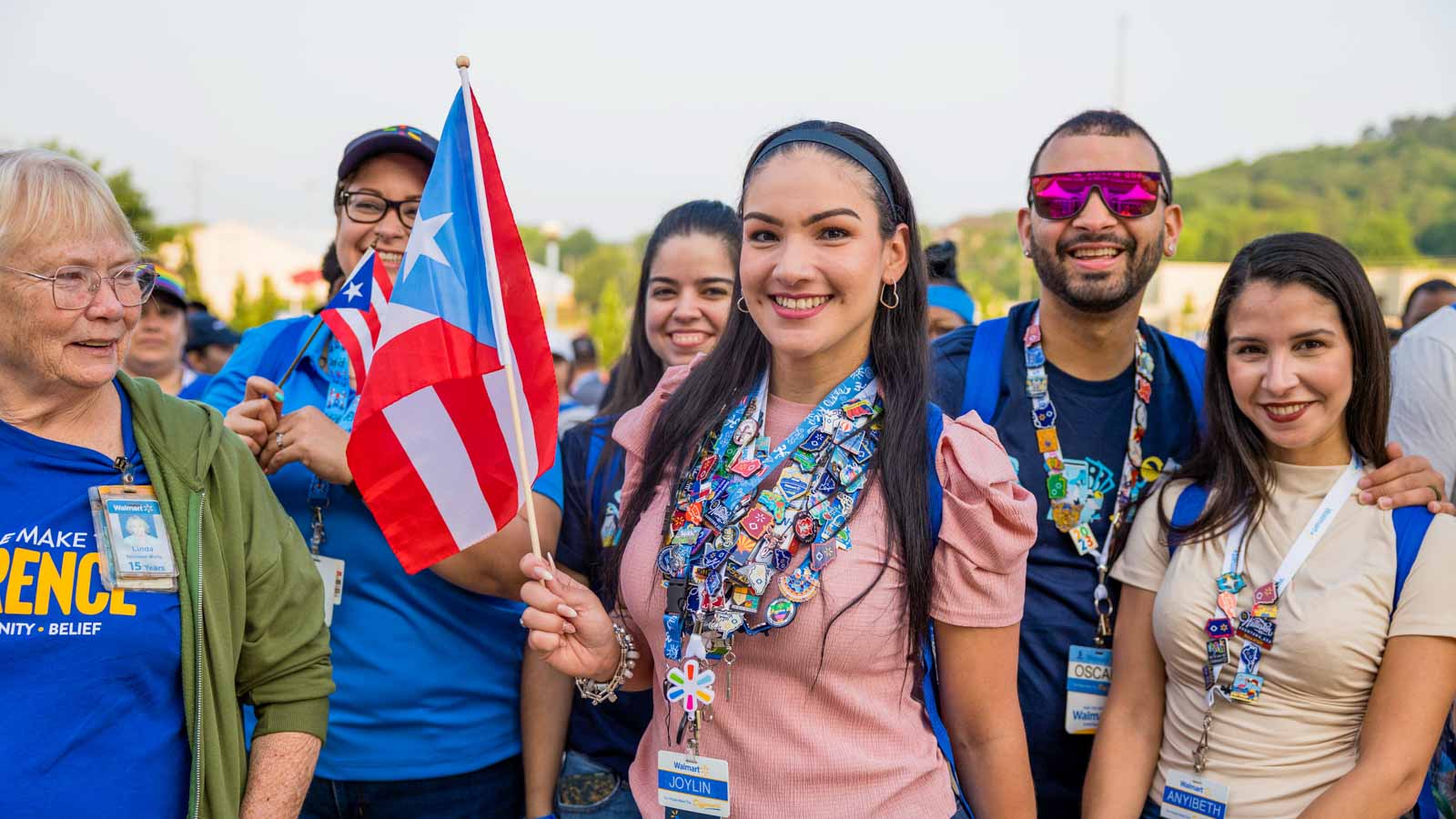 International associates wave their country's flag while posing for their picture.