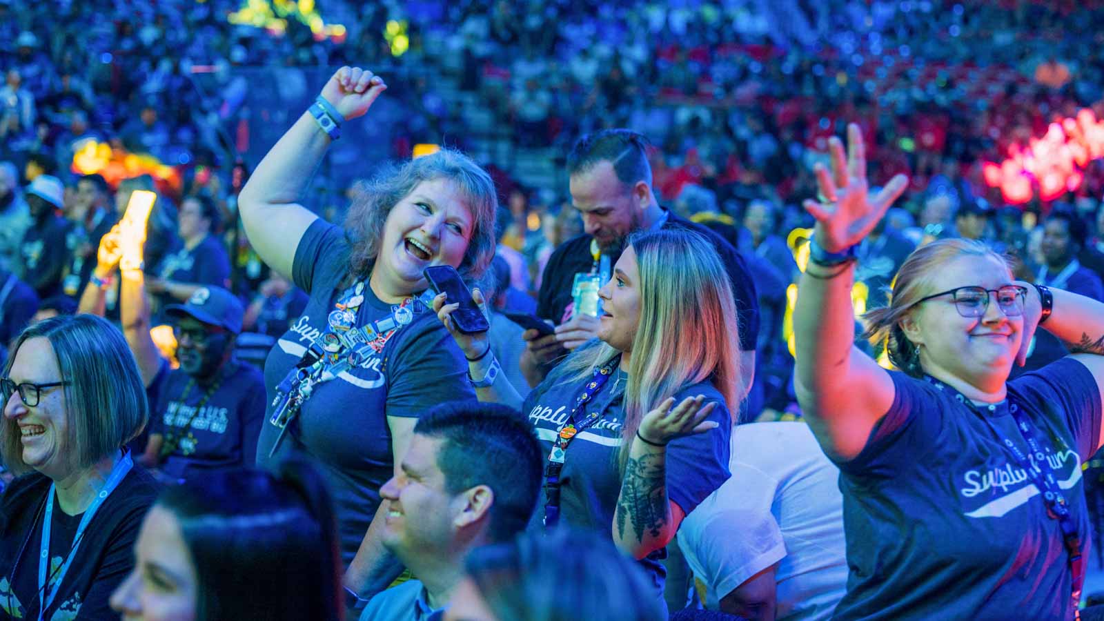 Associates dance and sing in Bud Walton Arena during Associate's Week 2023.