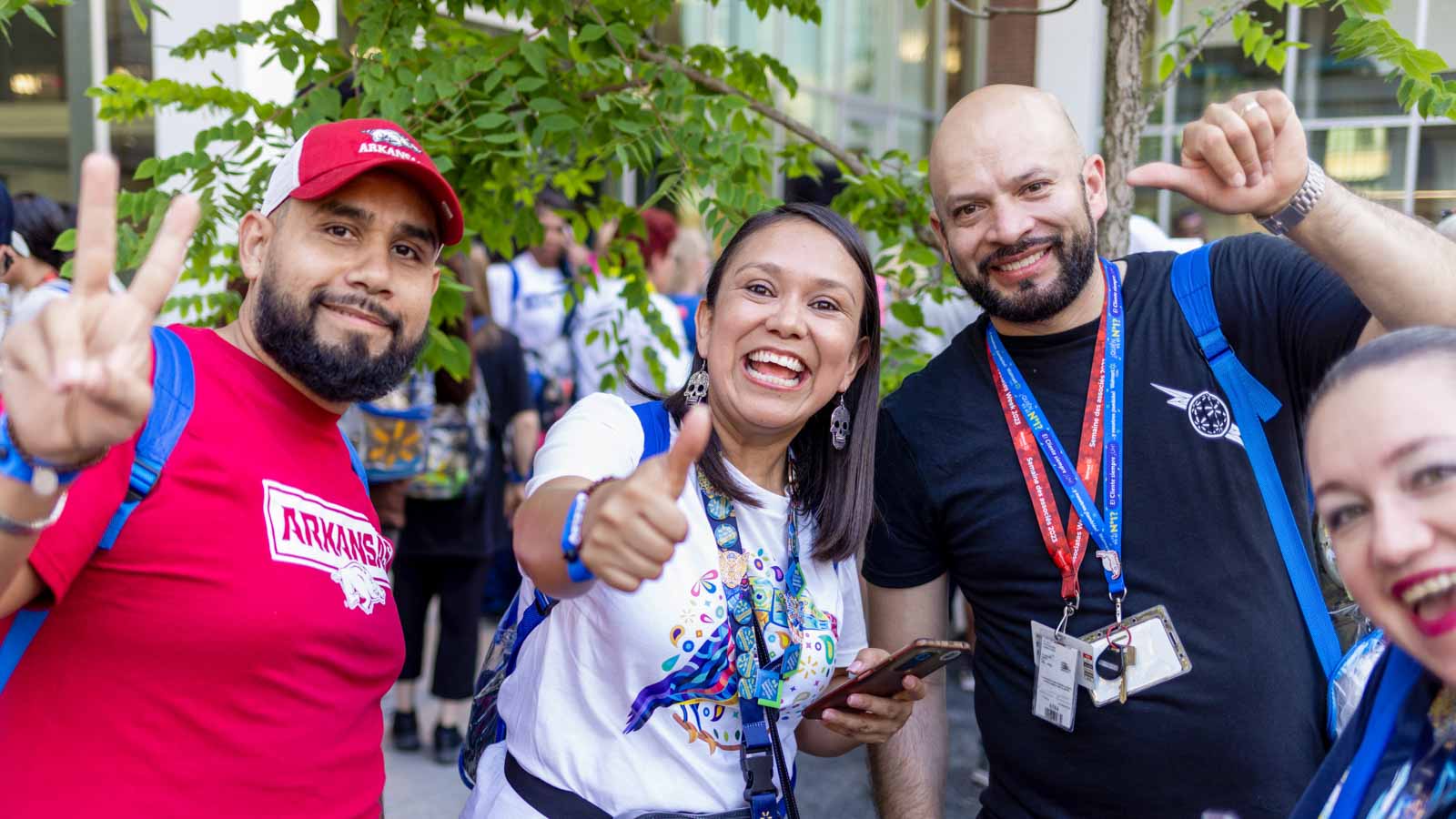 Associates give peace signs and thumbs up while enjoying Associate's Week.