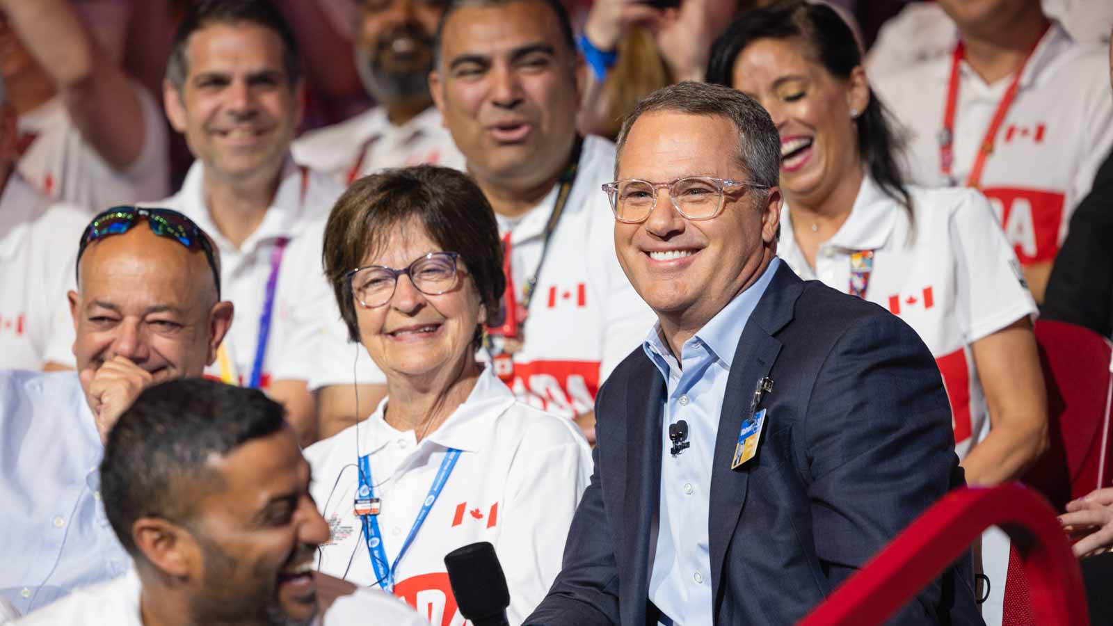 Doug McMillon sits with long time Canadian associate during Associate's Celebration at Bud Walton Arena in Fayetteville, Ark.