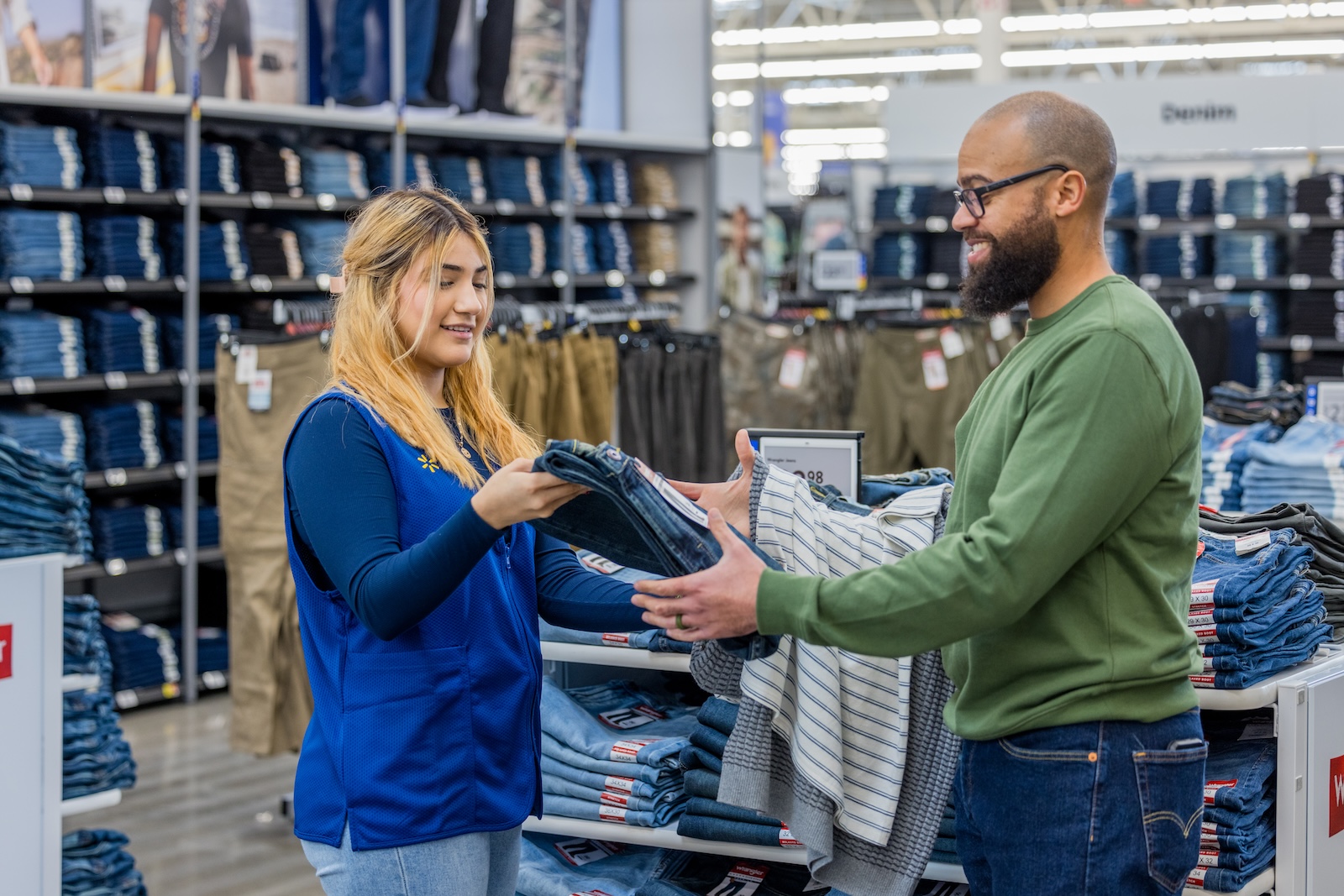 Walmart Associate helping a customer in the clothing department.