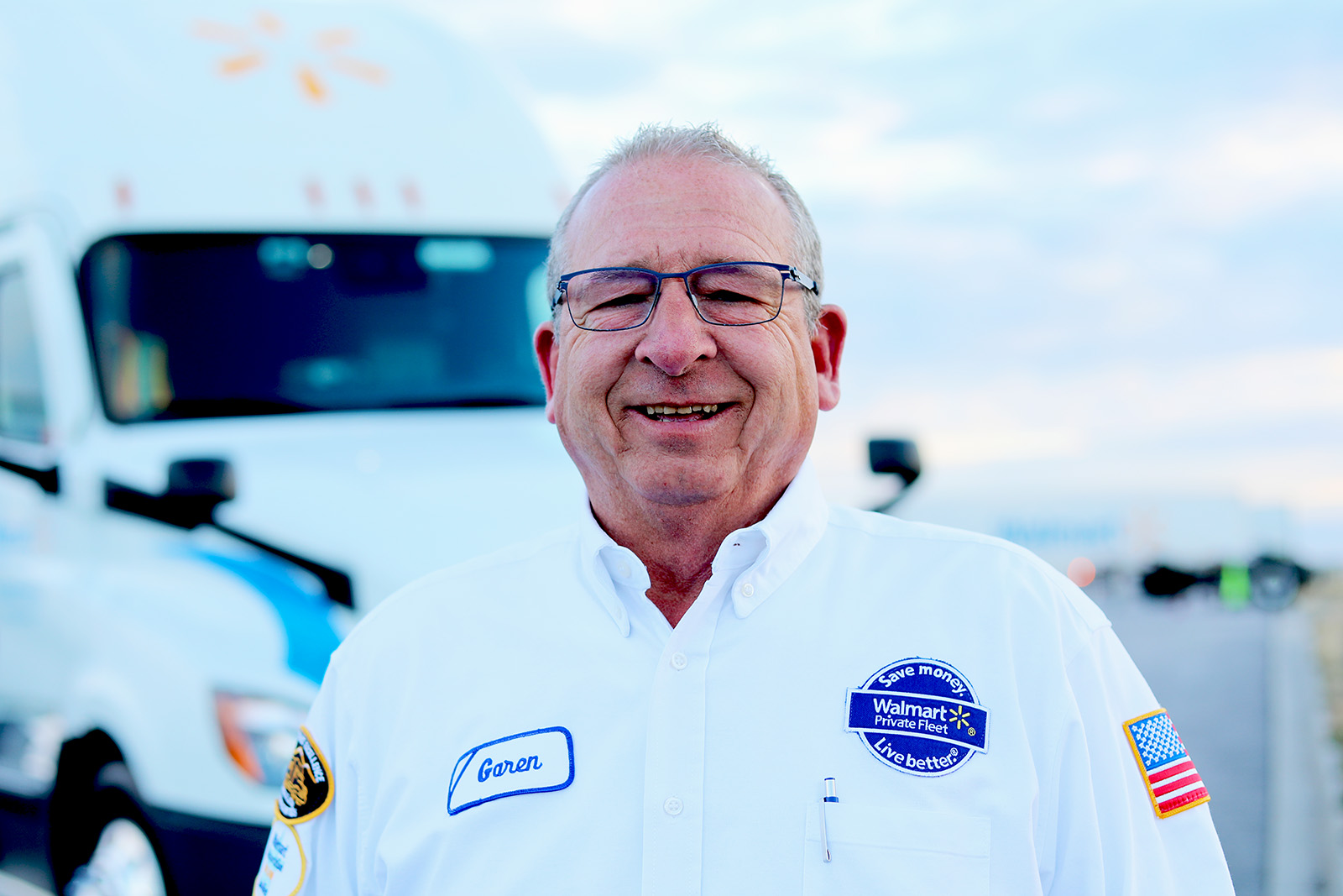 A row of Walmart associates in a classroom using tablets to complete classwork.