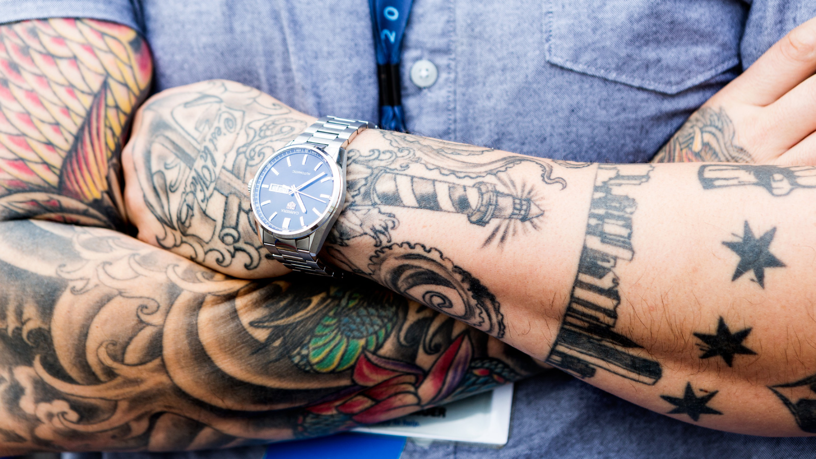 Close-up photo of Chico's folded arms covered with tattoos.