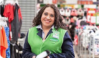 A Walmart associate smiles at the camera.